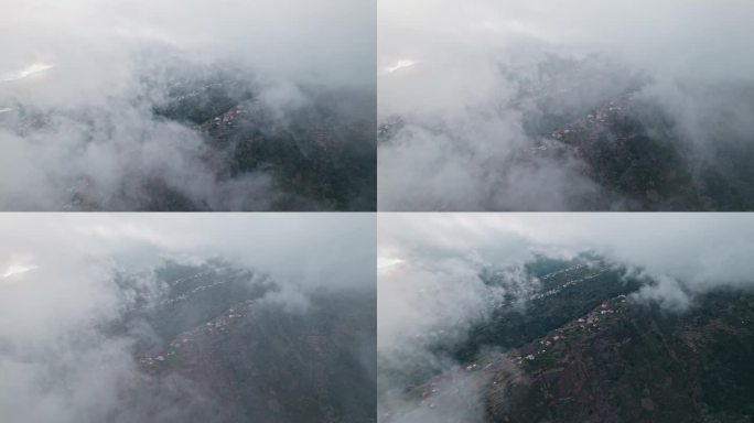 无人机穿越云层，揭示葡萄牙马德拉山中的村庄。