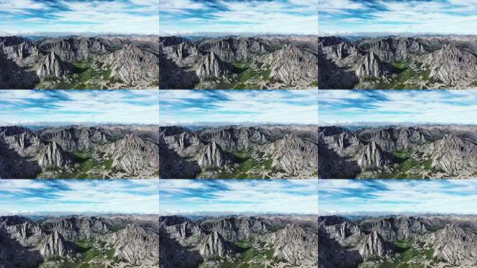 航拍蓝天白云下莲宝叶则的群峰和山谷