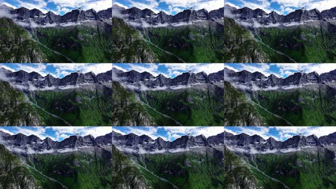 航拍蓝天白云下四姑娘山的群峰和山谷