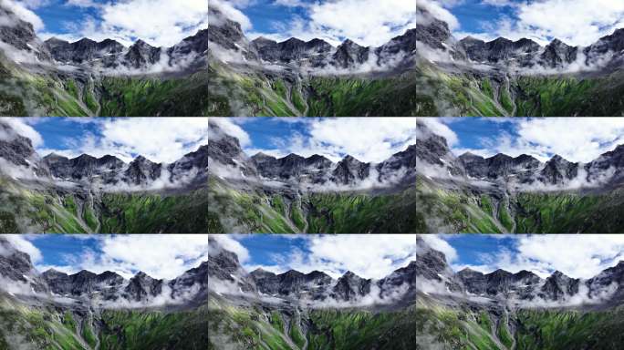 航拍蓝天白云下四姑娘山的群峰和山谷