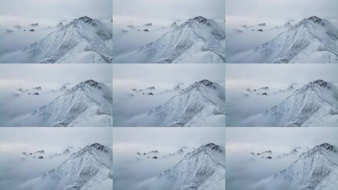 航拍云雾中的雪山水墨山峰