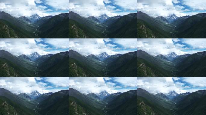 航拍阳光下云雾缭绕的雅拉雪山