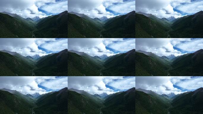 航拍阳光下云雾缭绕的雅拉雪山