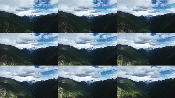 航拍阳光下云雾缭绕的雅拉雪山