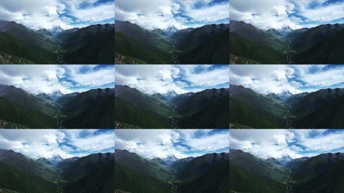 航拍阳光下云雾缭绕的雅拉雪山