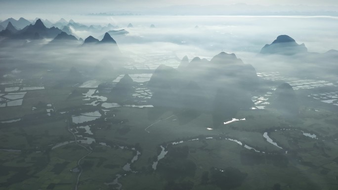 航拍日出云雾缭绕下喀斯特地貌稻田风光