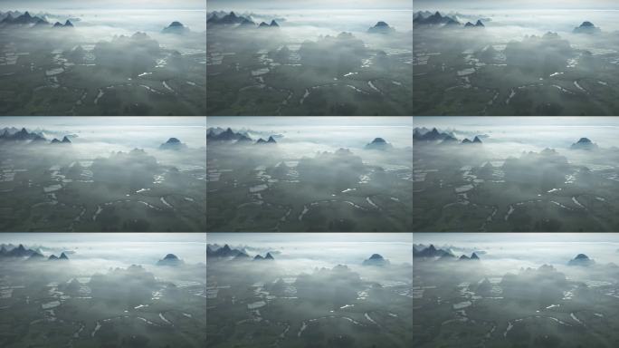 航拍日出云雾缭绕下喀斯特地貌稻田风光