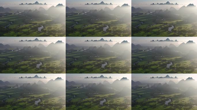 航拍日出云雾缭绕下喀斯特地貌稻田风光