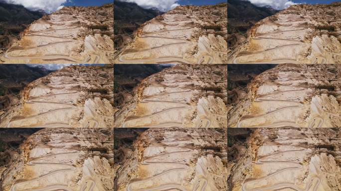 无人机拍摄尼泊尔红褐色沙漠峡谷中蜿蜒的狭窄山路。