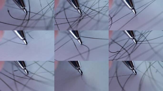 圆珠笔在白纸上绘画线条，微距特写镜头