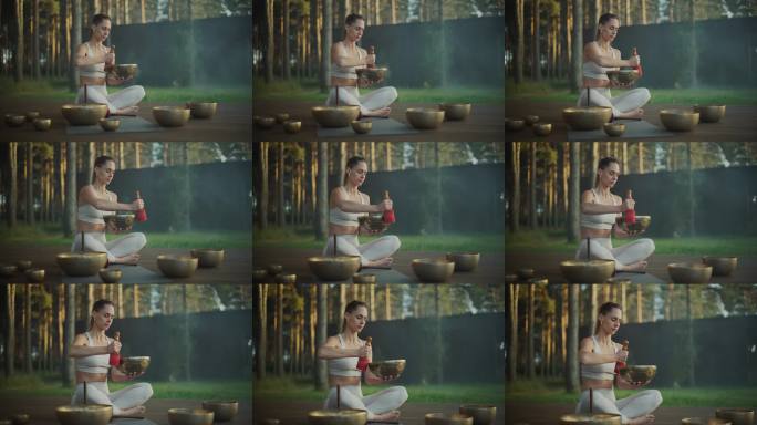 一位女性轻柔地用棒子沿着唱碗的边缘滑动，发出共鸣的声音。冥想的音调加深了她的修行，充满了空间的宁静振