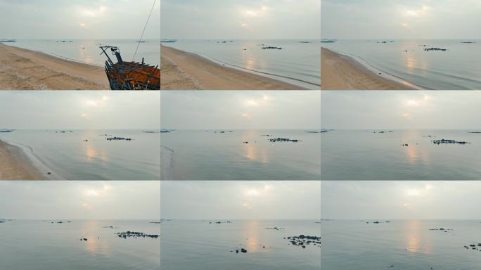 海边破旧木船风景 航拍唯美清晨海上日出