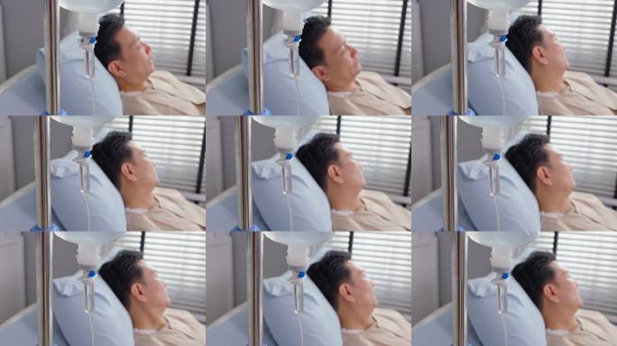 特写镜头：成熟男性患者在医院病房接受生理盐水治疗。年长的病人躺在恢复室的床上，等待医生的治疗。