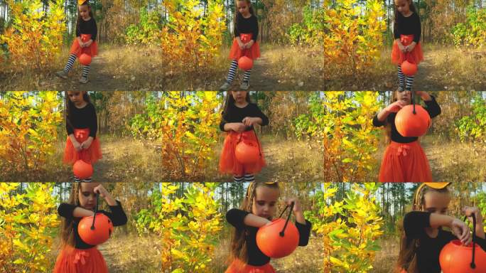 一个穿着嘉年华女巫服装的女孩手里拿着一个装糖果的桶。万圣节的“不给糖就捣蛋”拿糖果。童年、传统和乐趣