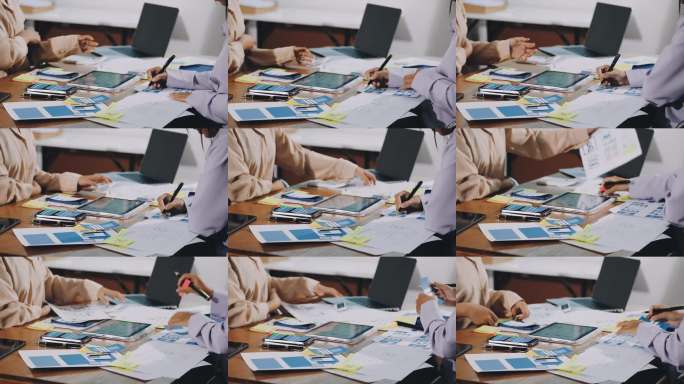 UX/UI设计师正在为网站和移动应用原型制作线框图，周围是用户流程和设计工具的草图，构思网站和移动应