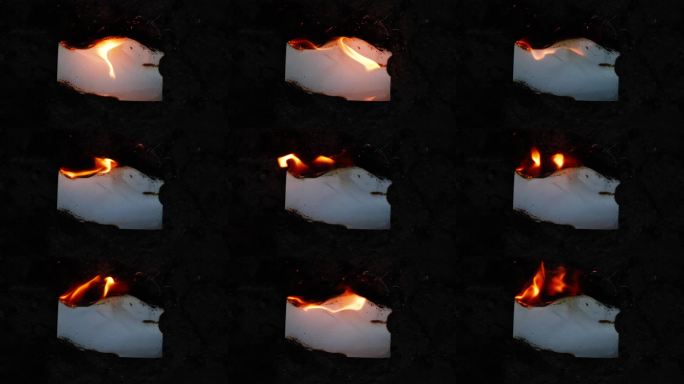 燃烧和发光的照片或纸张，伴随火焰和烟雾，背景为黑色。