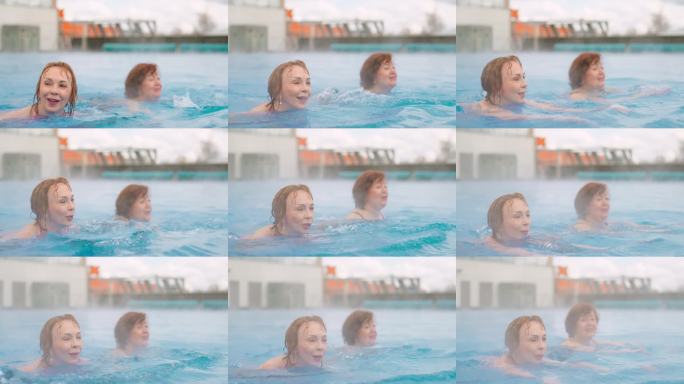 快乐放松，老年女性在水疗中心的户外游泳池中游泳，老年女性的肖像。