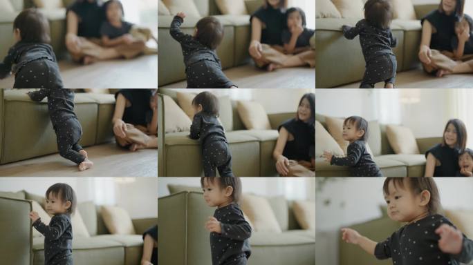 可爱的小女孩在家里和妈妈待着，站着尝试自己走路。