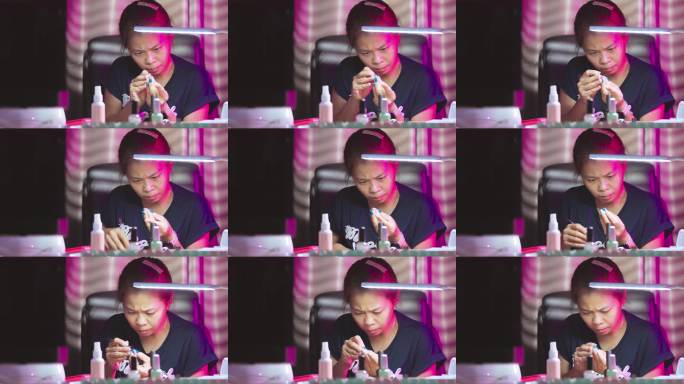 亚洲女性在家客厅里做美甲艺术。